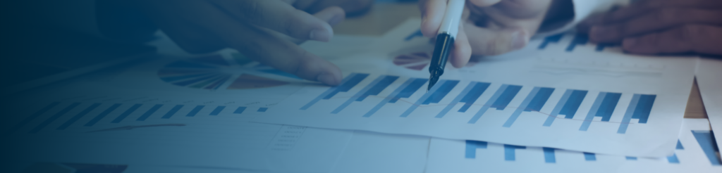 Hands pointing at graphs and bar charts, representing tax analysis and compliance guidance in Denmark