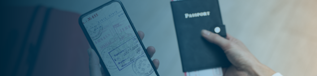 Person holding a smartphone with digital passport stamps next to a physical passport.