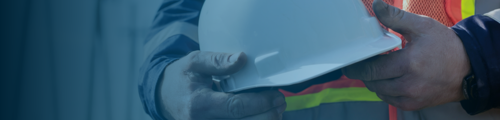 Construction worker receiving safety helmet on Danish construction site